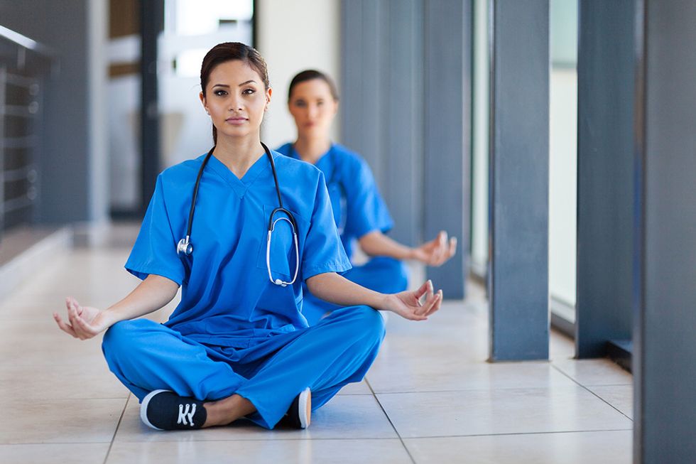 Healthcare workers take a break to meditate.