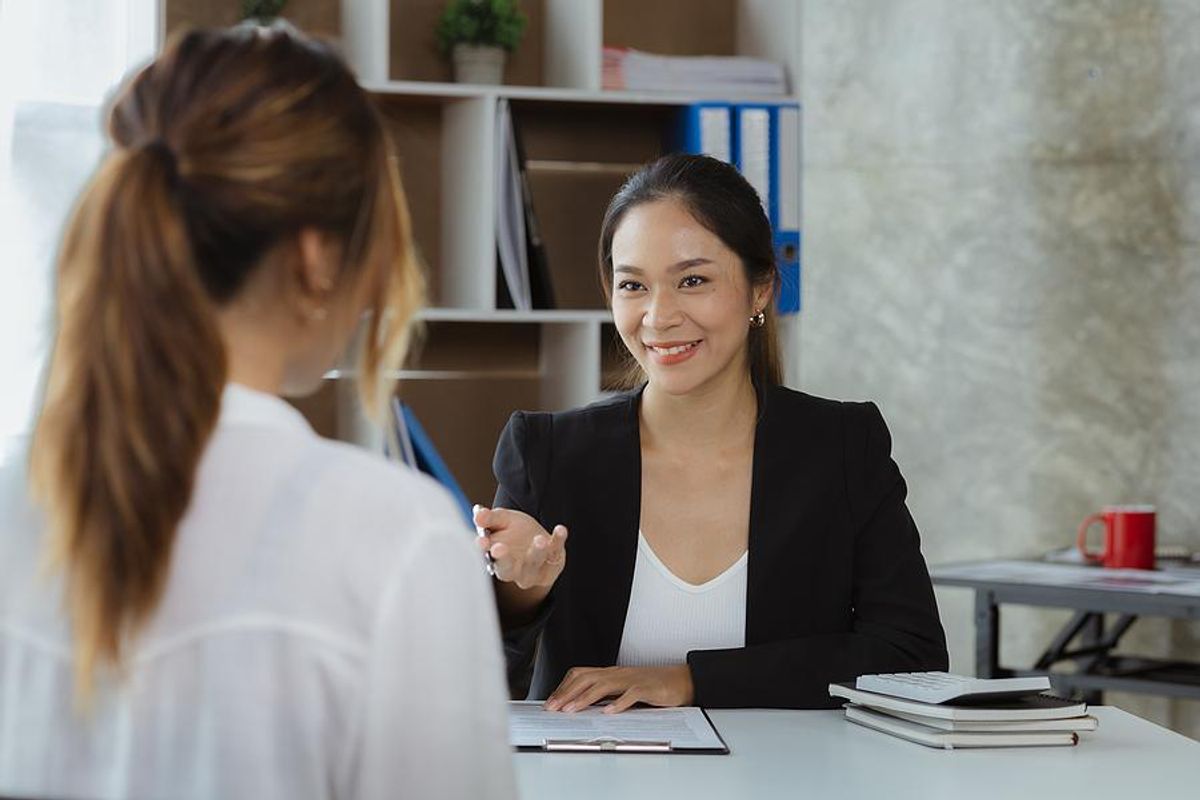 Hiring manager asks a job candidate a question during an interview