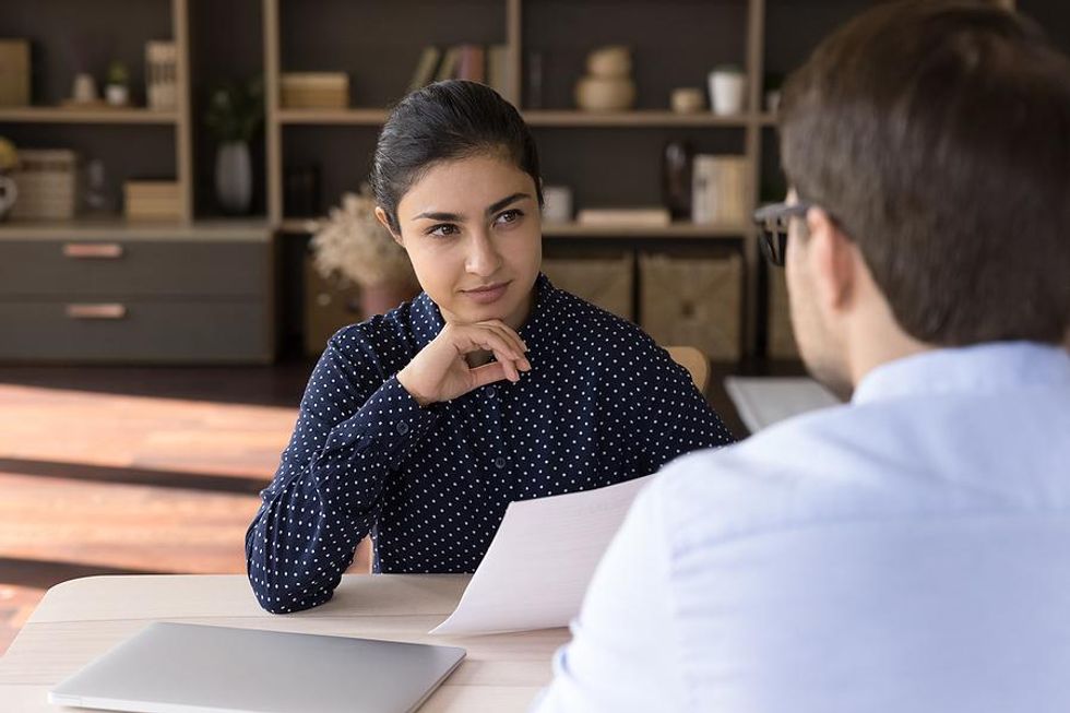 Hiring manager asks job candidate how they handle a heavy workload during an interview
