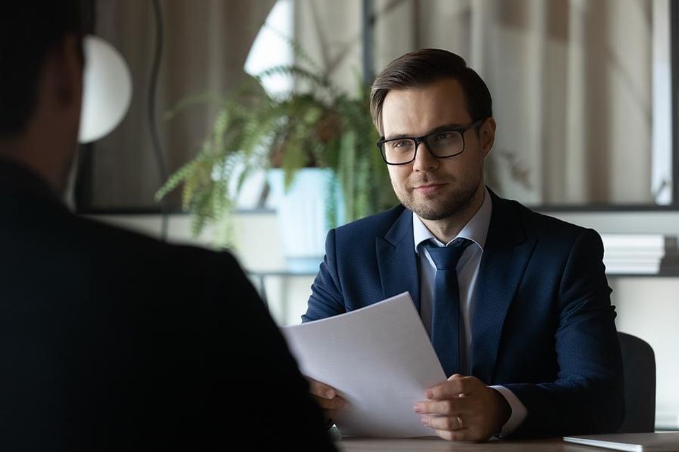 Hiring manager listens to a job candidate answer an interview question