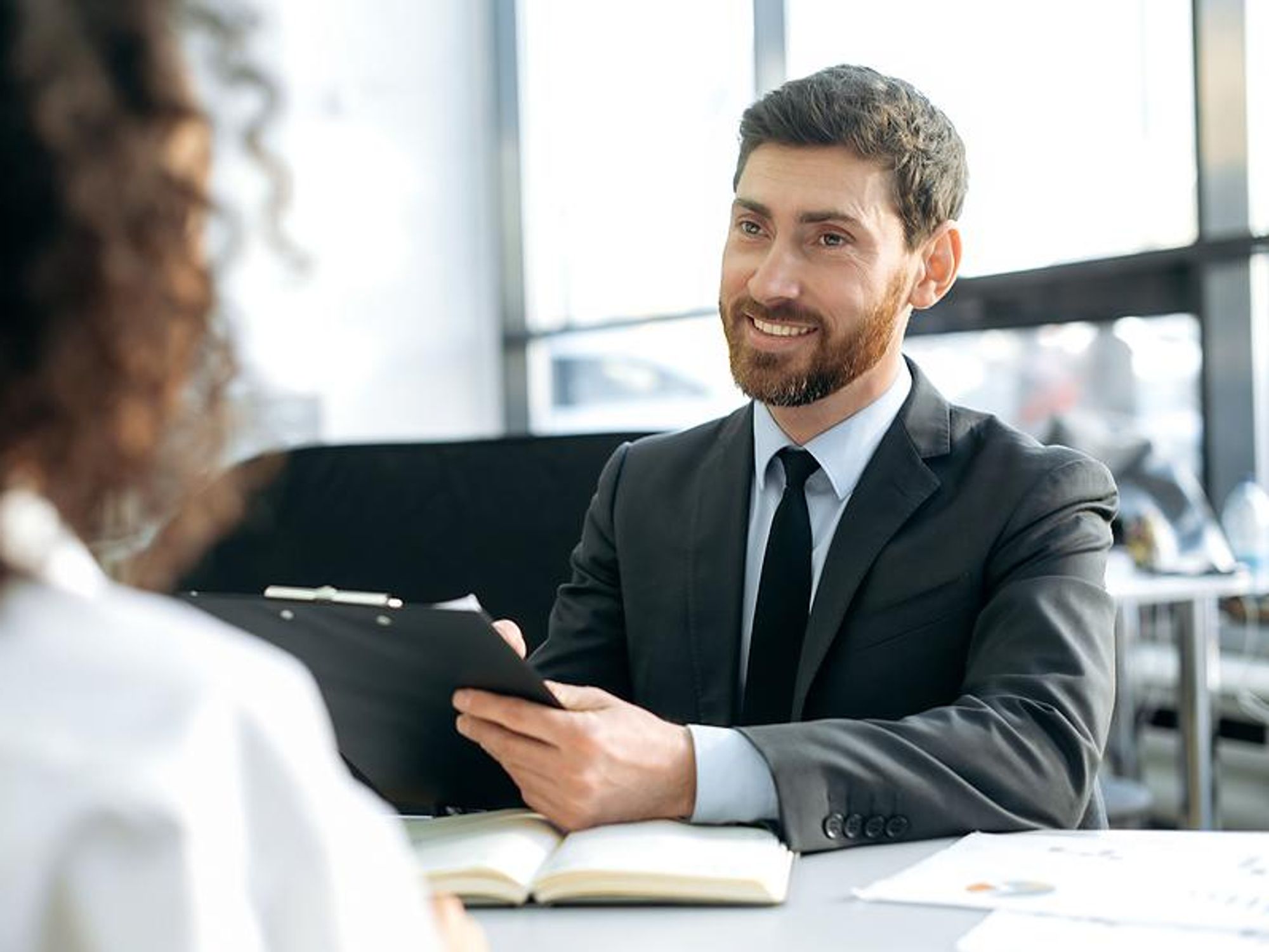 Hiring manager listens to a job candidate's answer to an interview question