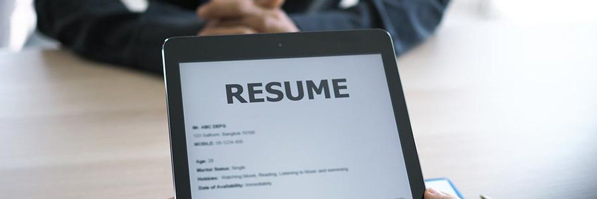 Hiring manager looks at the job applicant's resume