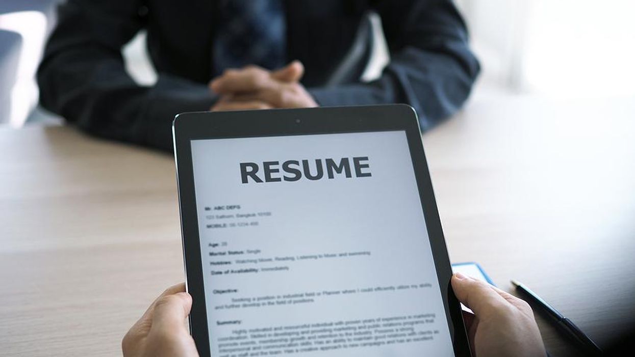 Hiring manager looks at the job applicant's resume