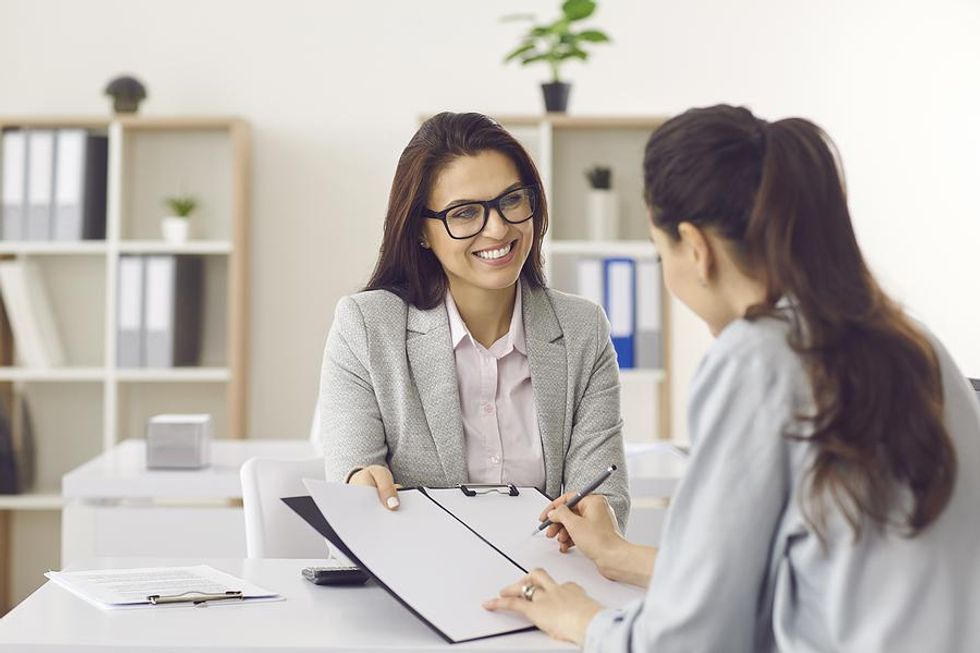 Hiring manager offers the job to a female job candidate after an interview