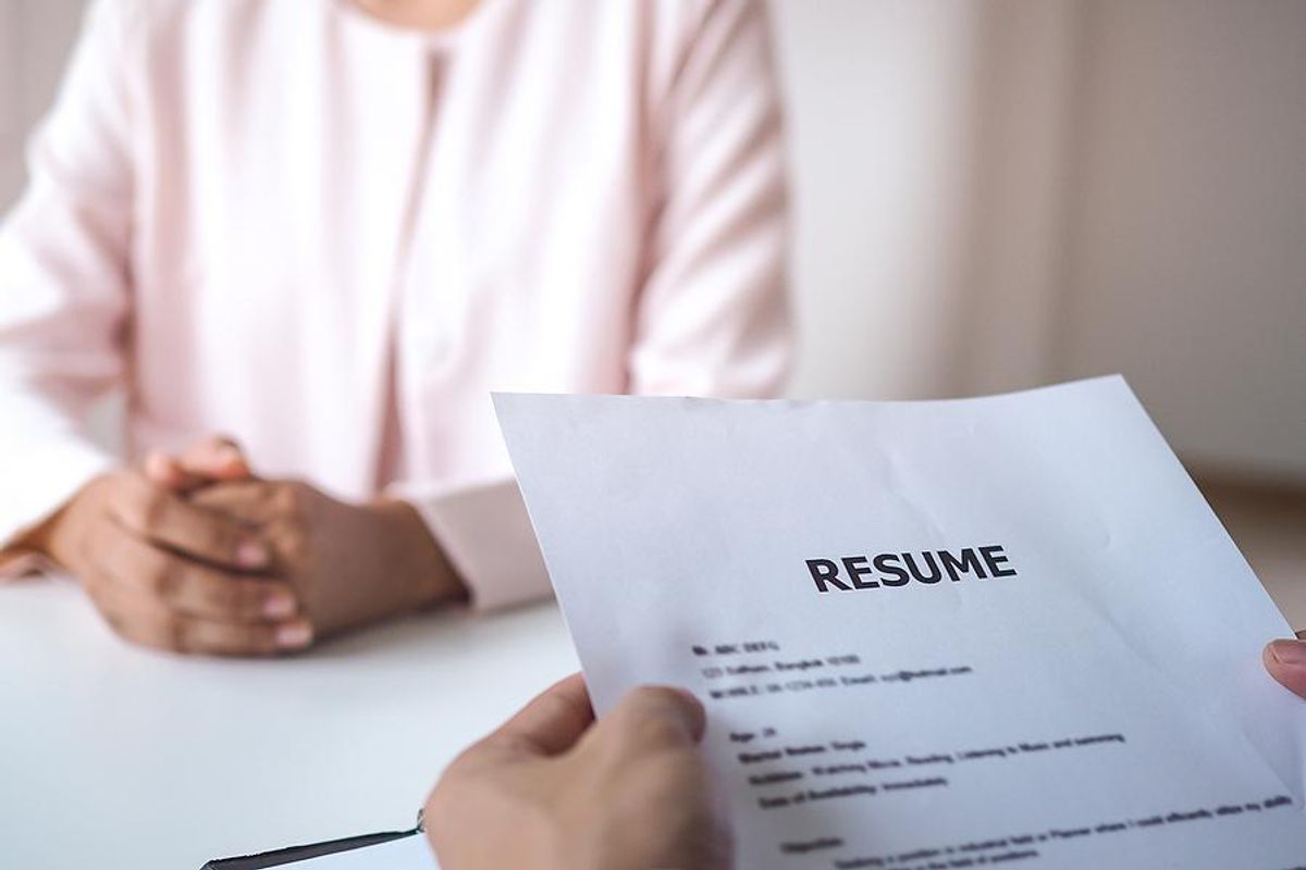 Hiring manager reads a job applicant's resume