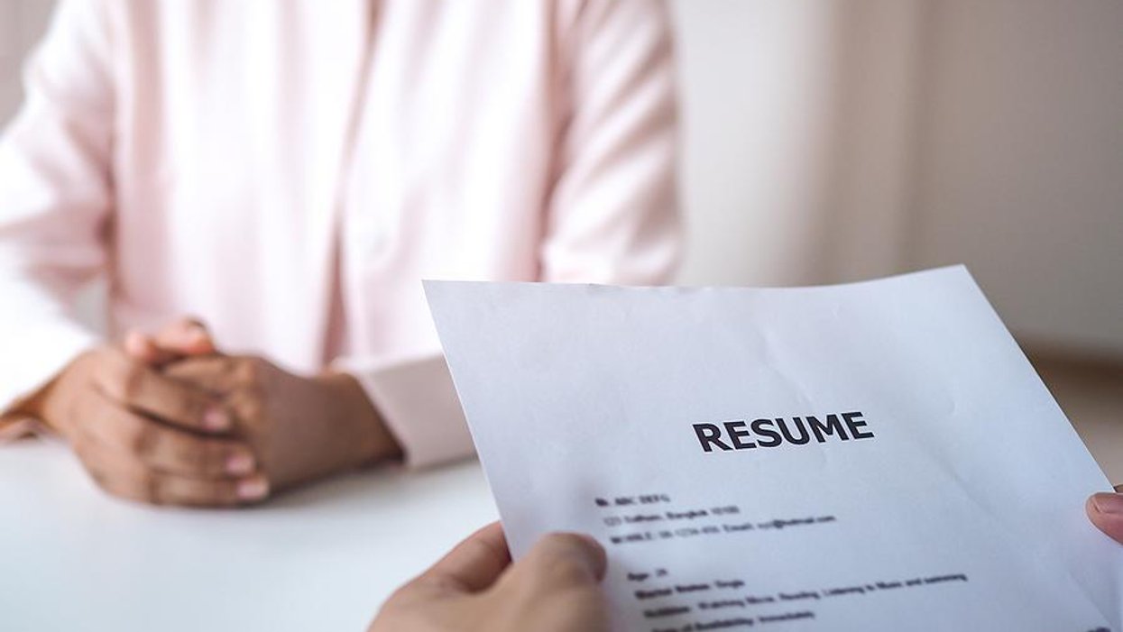 Hiring manager reads a job applicant's resume