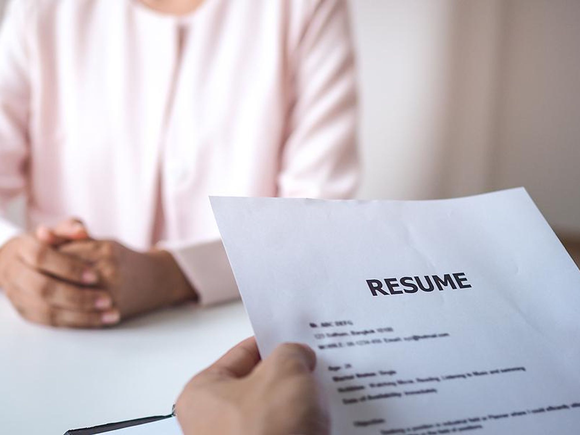 Hiring manager reads a job applicant's resume