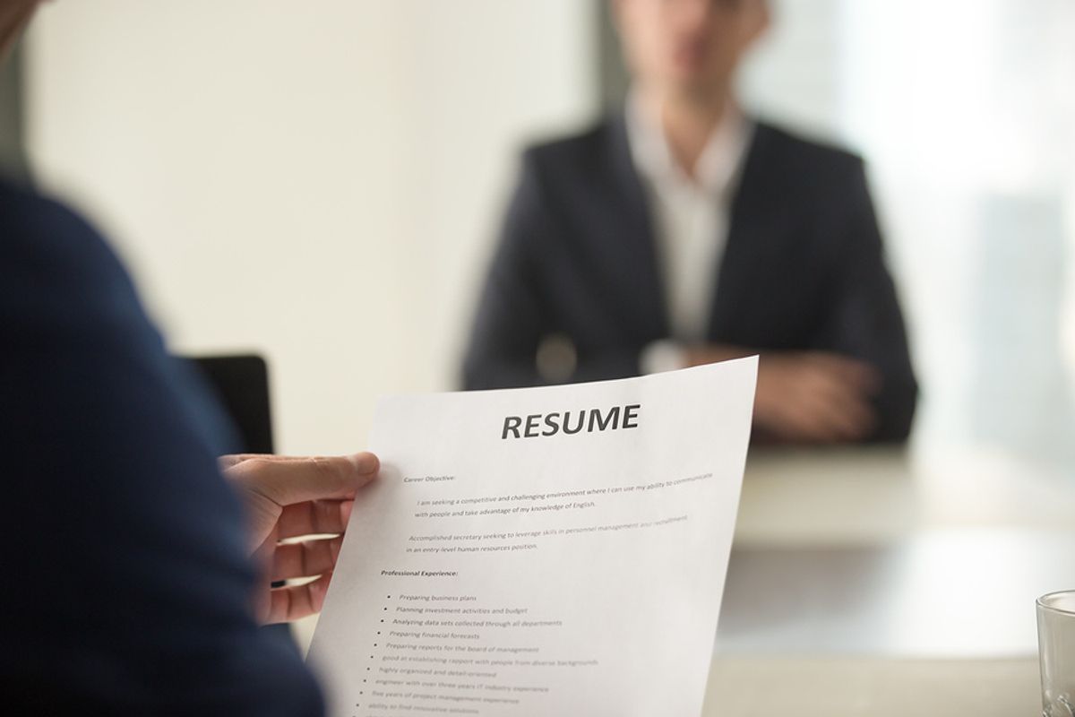 Hiring manager reads a resume with good punctuation