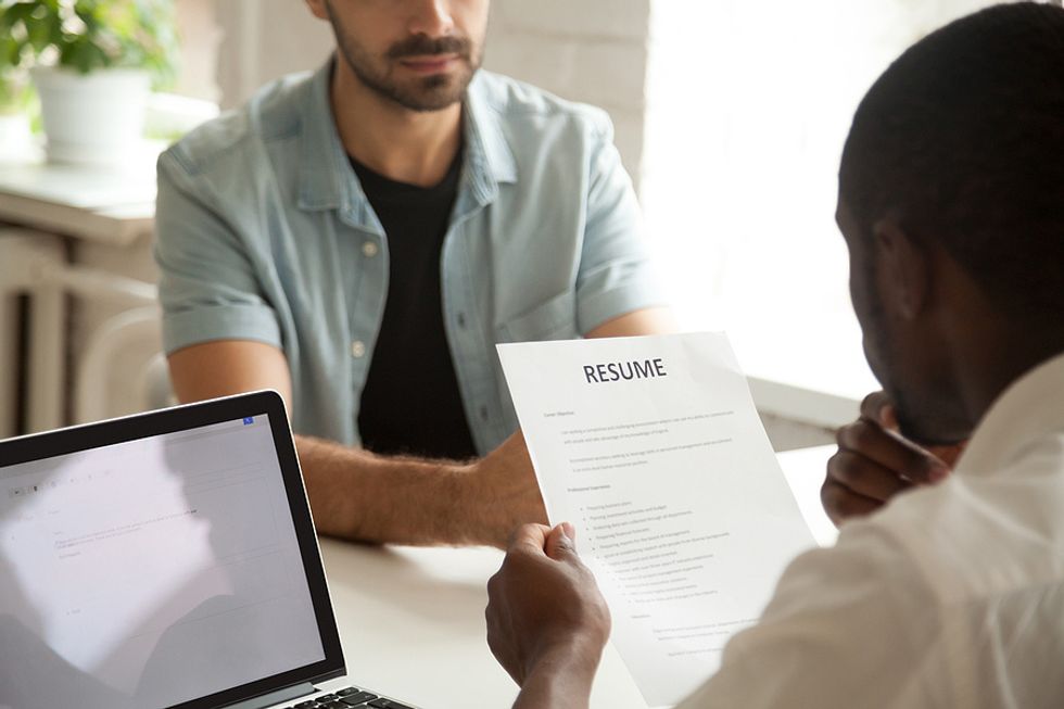 Hiring manager reads about the job applicant's ROI on his resume during an interview