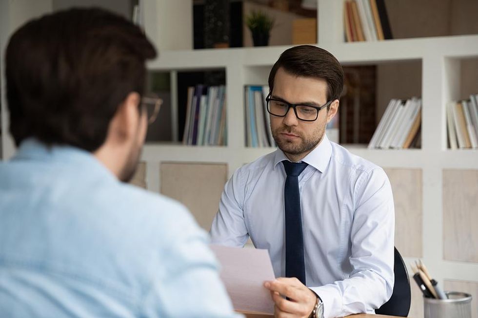 Hiring manager reviews documents from a job candidate