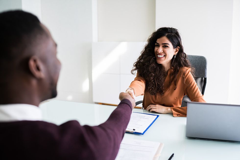 Hiring manager shakes the hand of an enthusiastic job candidate