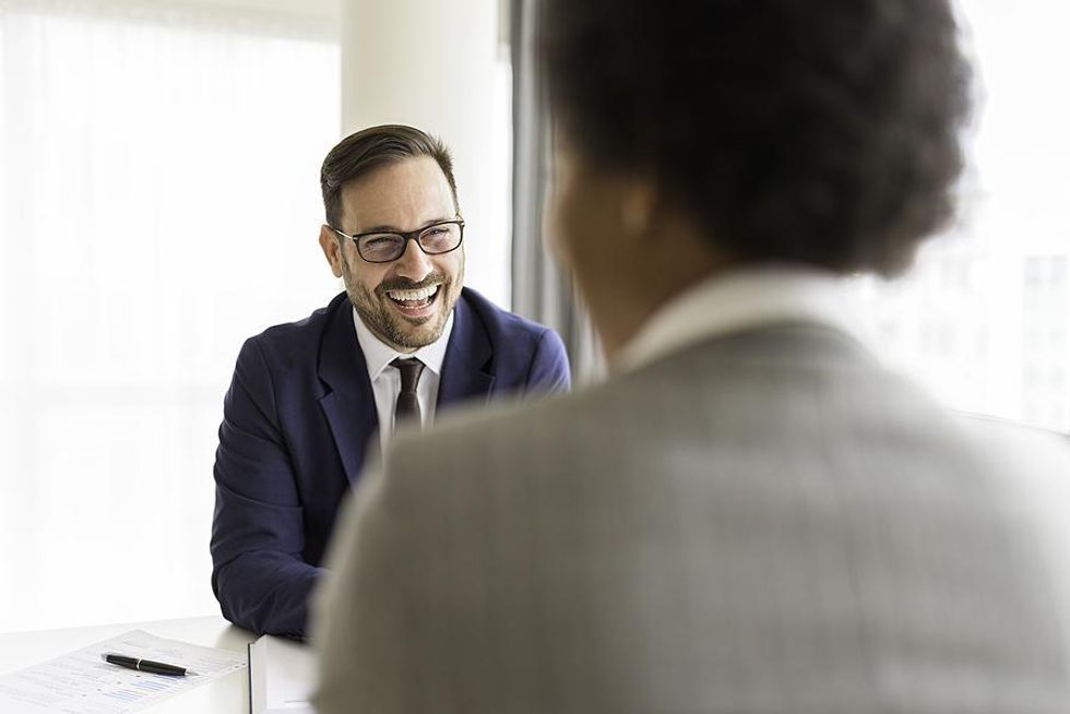 Hiring manager smiles at a job candidate