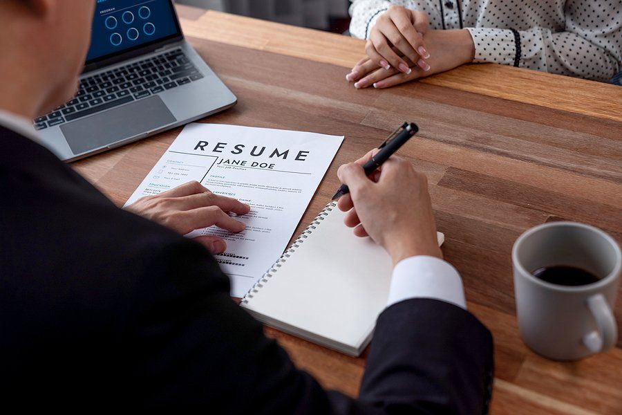 Hiring manager takes notes during an interview with a job candidate
