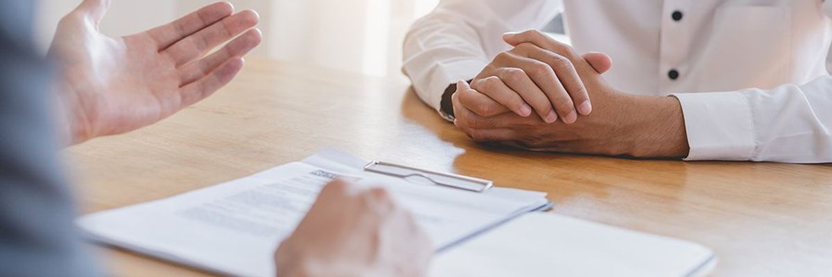 Hiring manager talks to a job candidate about the position during a job interview