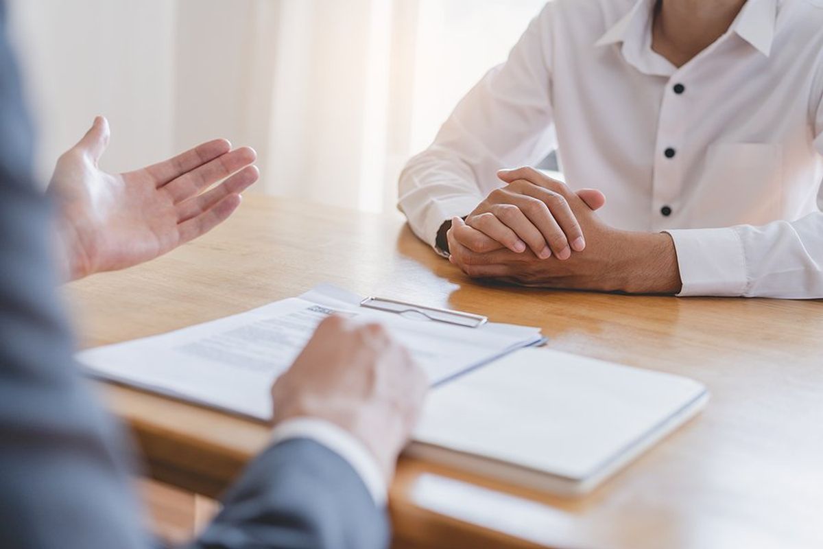 Hiring manager talks to a job candidate about the position during a job interview