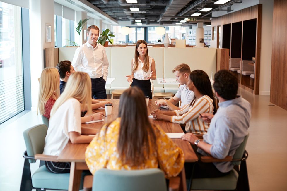 Hiring manager talks to job candidates during a group interview