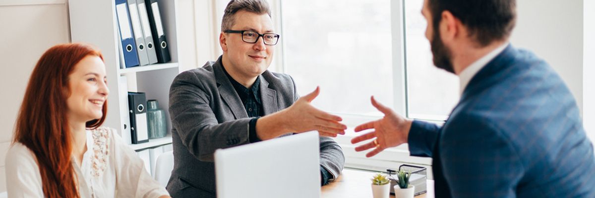 Hiring managers speak with a job seeker.
