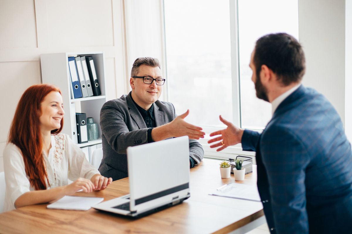 Hiring managers speak with a job seeker.