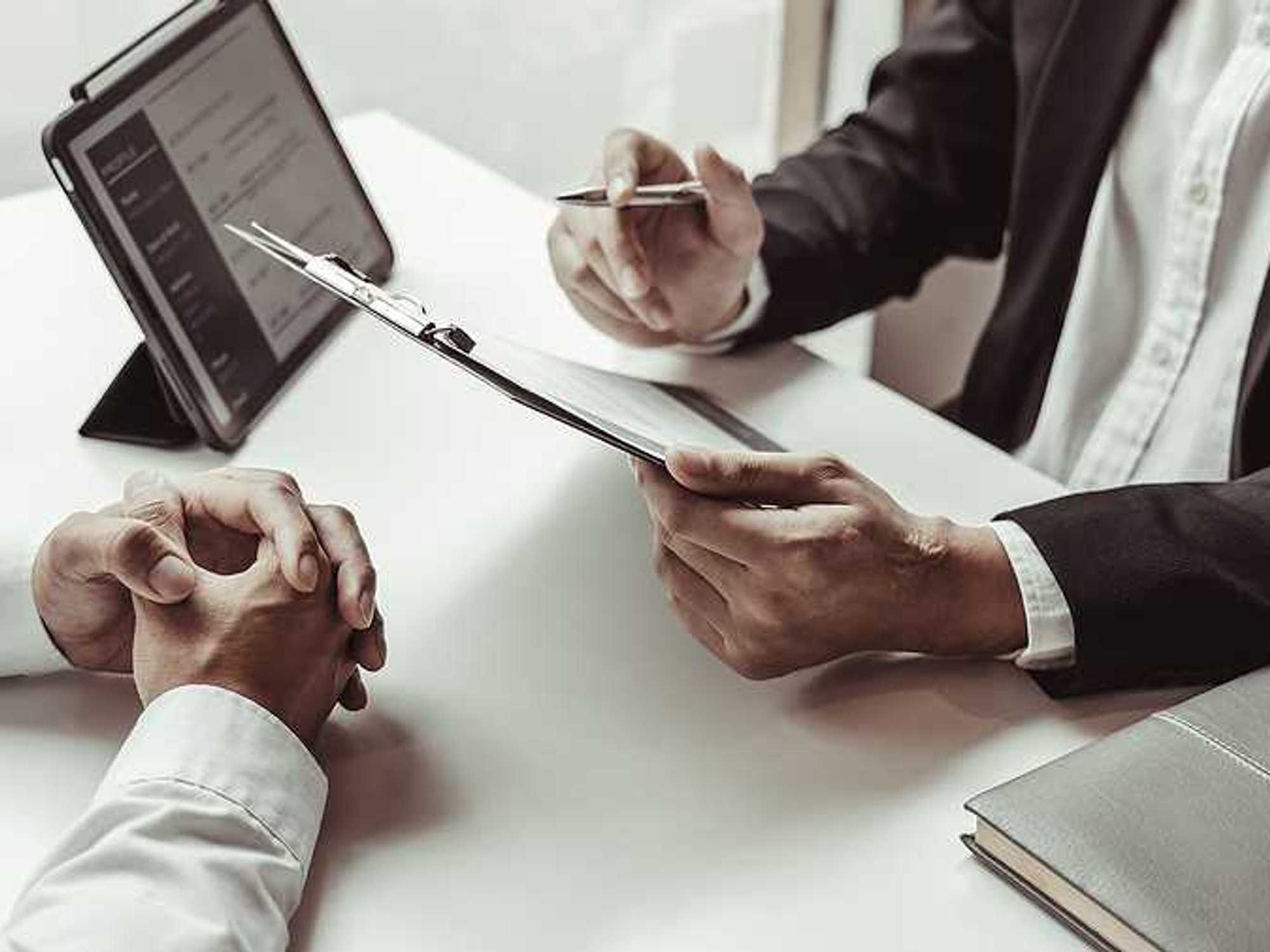 HR leader reads a job applicant's resume during a job interview