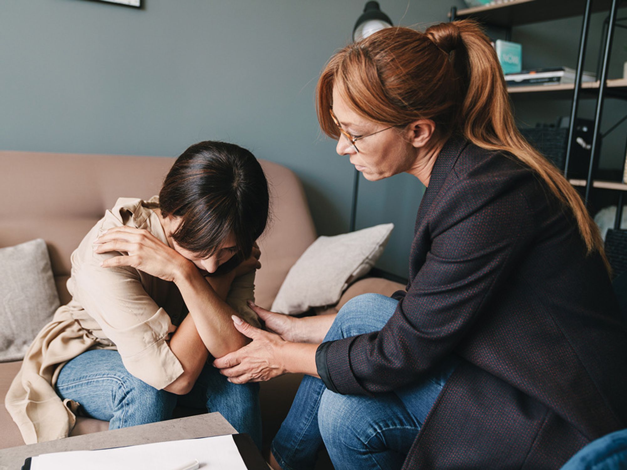 Human resources associated comforts an employee during a layoff.