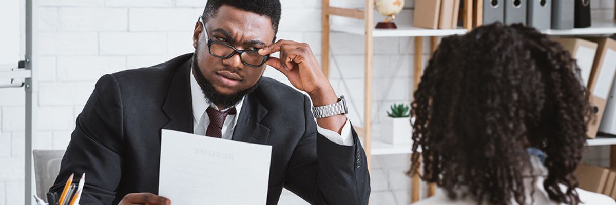 Interviewer looks confused at college students resume.