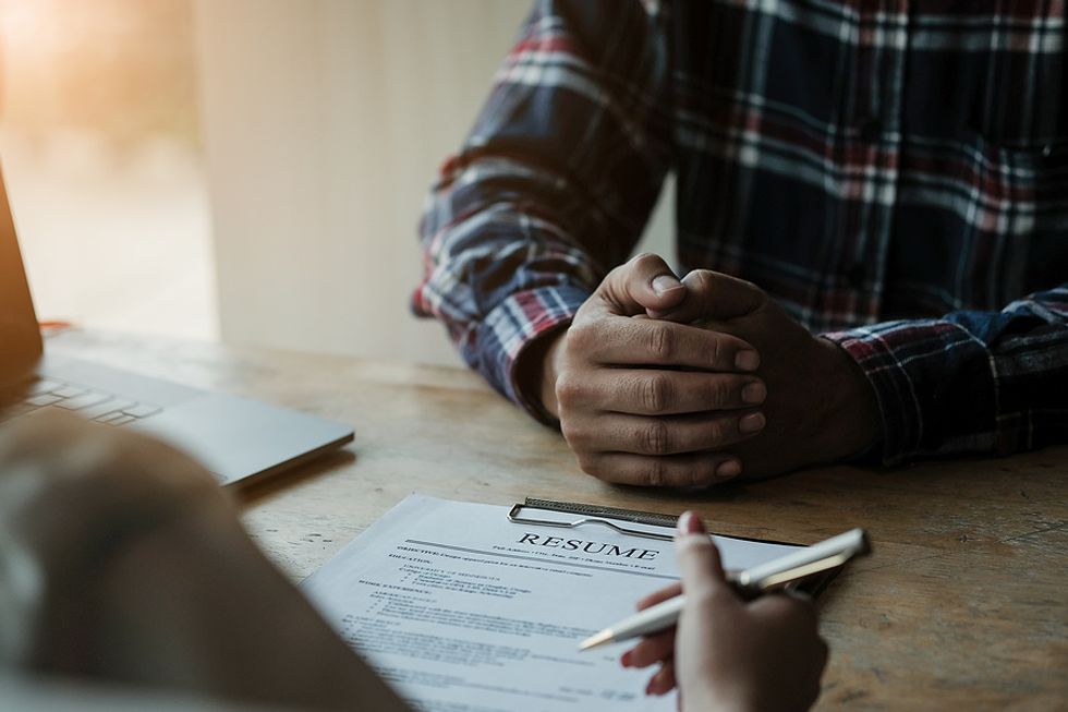 Interviewer references a job applicant's resume during an interview