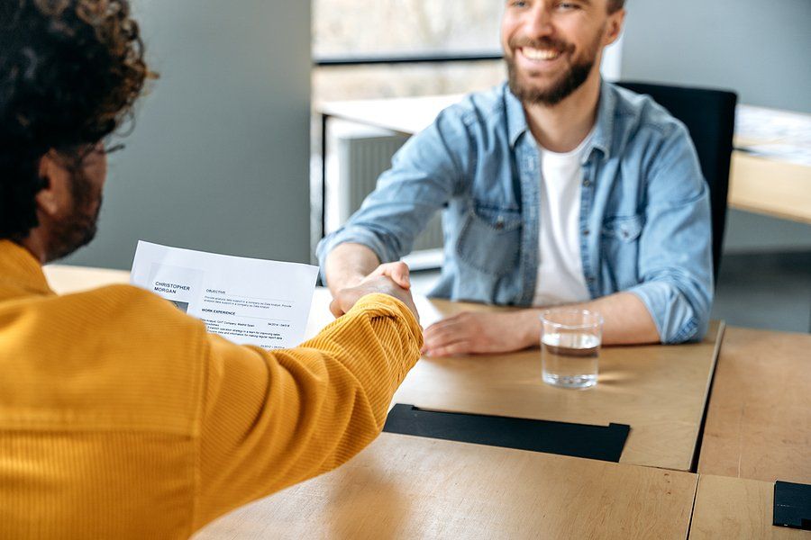 Job candidate shakes hands with the hiring manager before a job interview