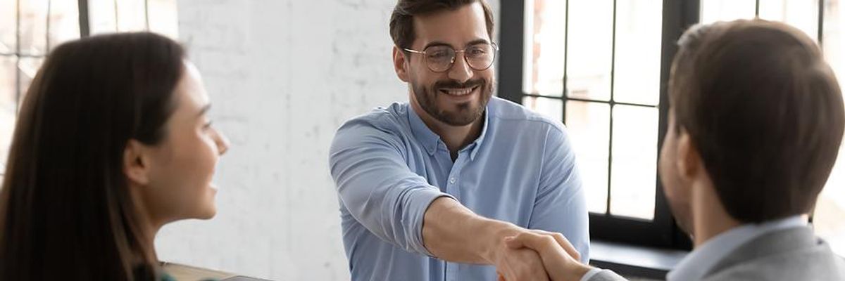Job candidate shakes the hiring manager's hand