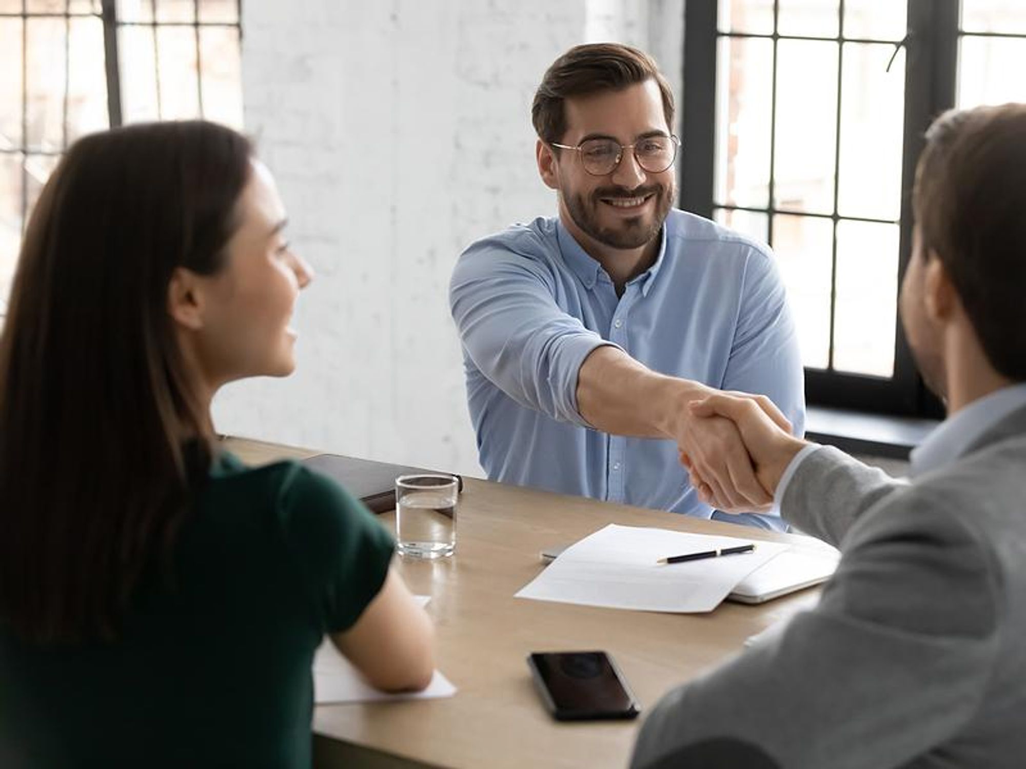 Job candidate shakes the hiring manager's hand