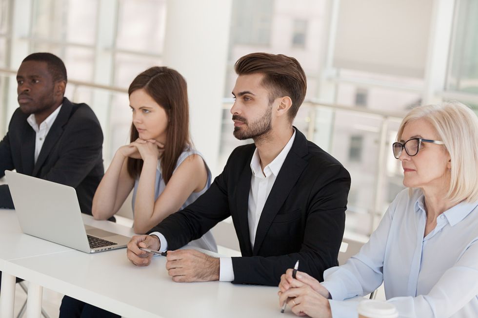Job candidates listen during a group interview