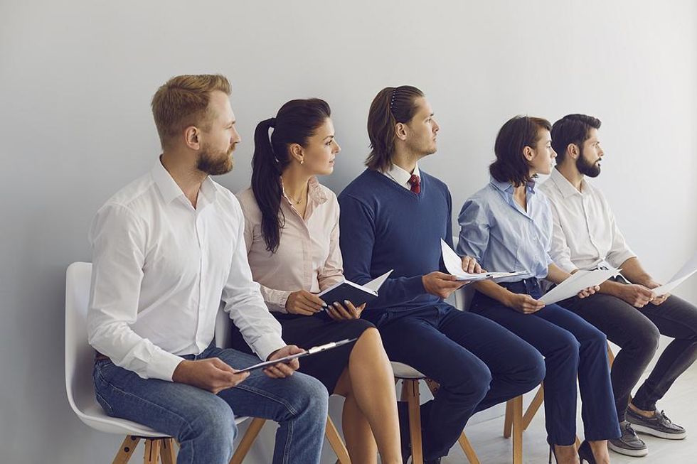 Job candidates wait for their interviews with a staffing agency