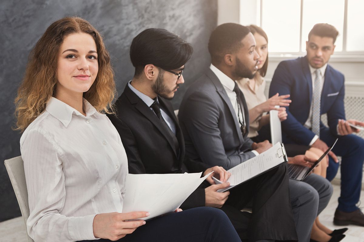 Job seeker holds her resume without any outdated phrases while waiting for an interview