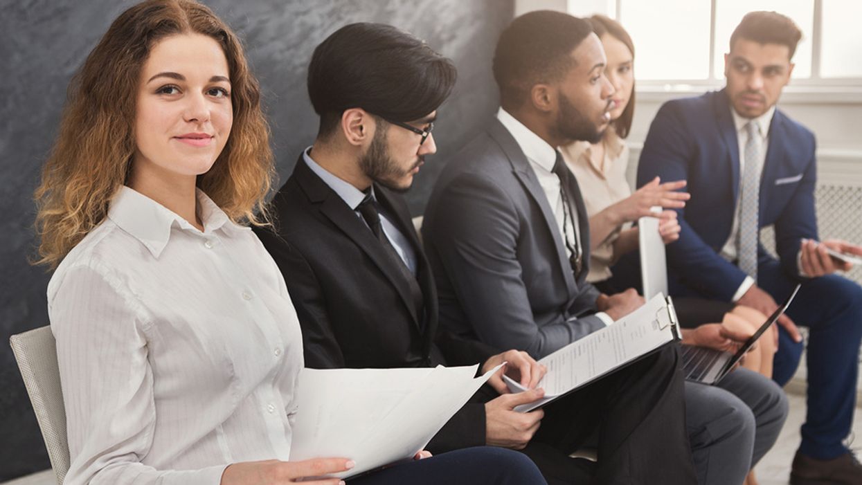 Job seeker holds her resume without any outdated phrases while waiting for an interview
