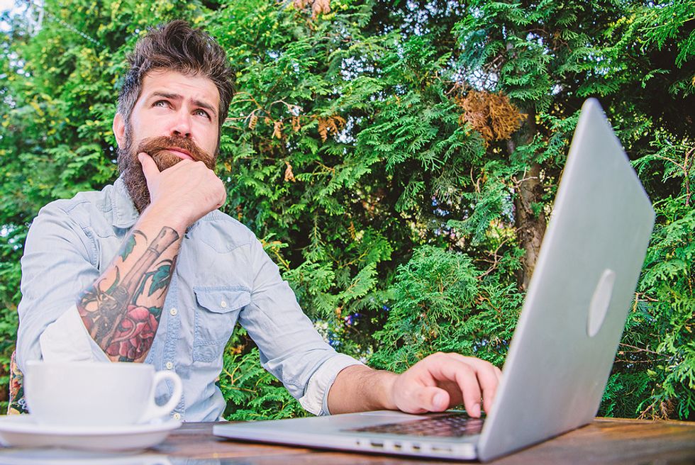 Job seeker on laptop struggles to write his resume