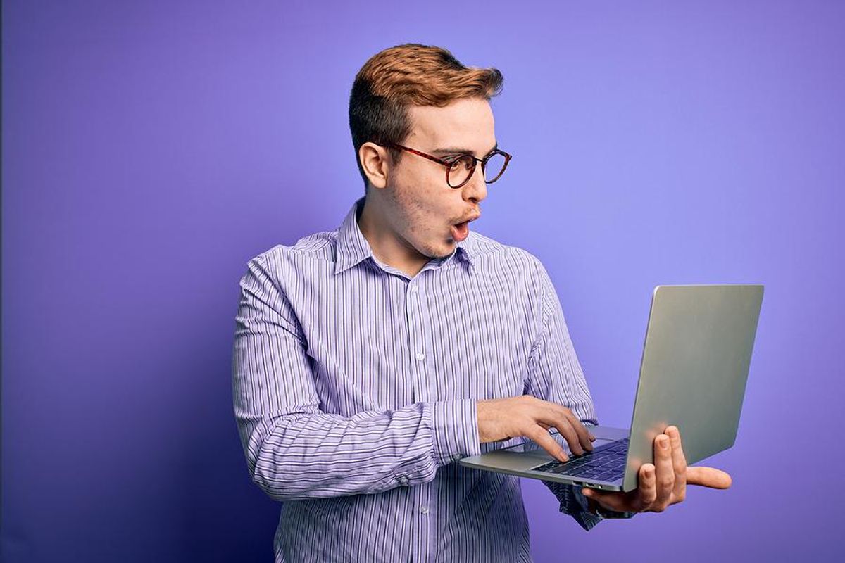Job seeker reads something shocking on his laptop