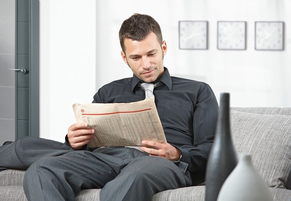 Job seeker reads the business section of his local newspaper.