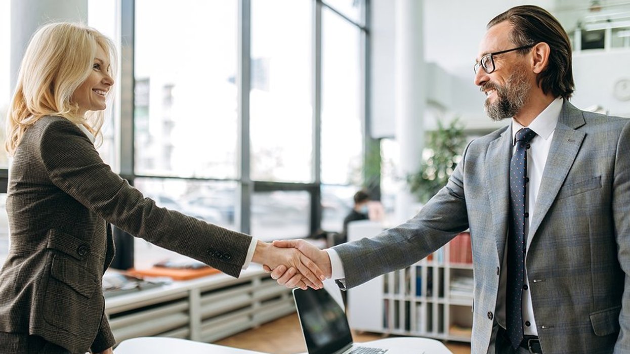 Job seeker shakes hands with the hiring manager before a job interview