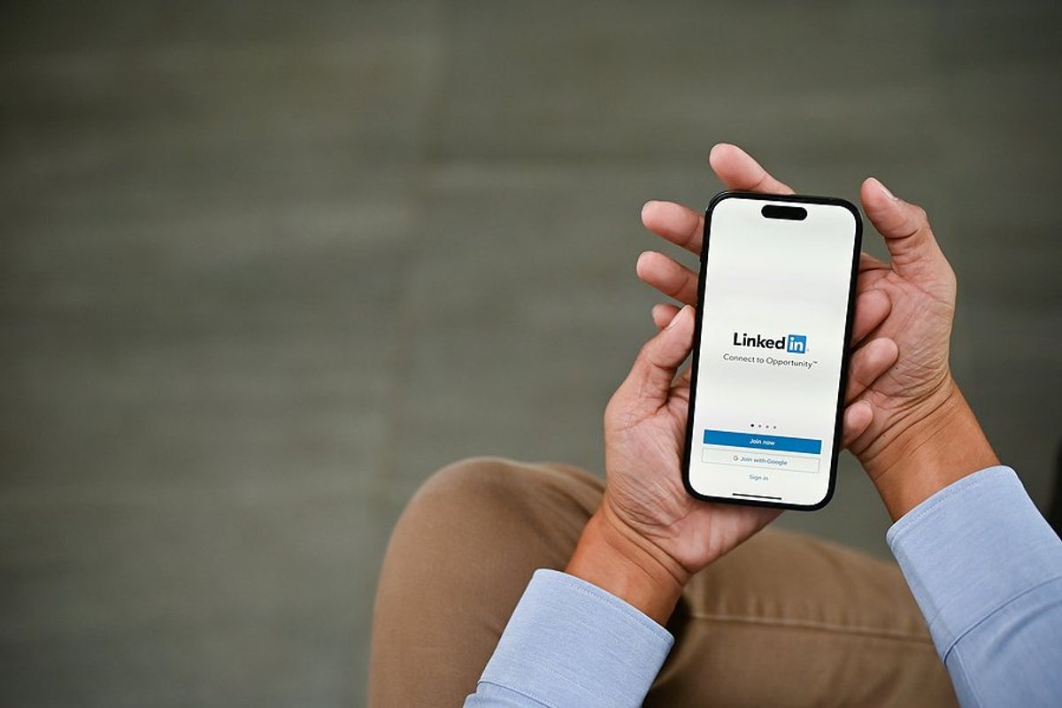 Job seeker uses LinkedIn on his phone to stand out to recruiters