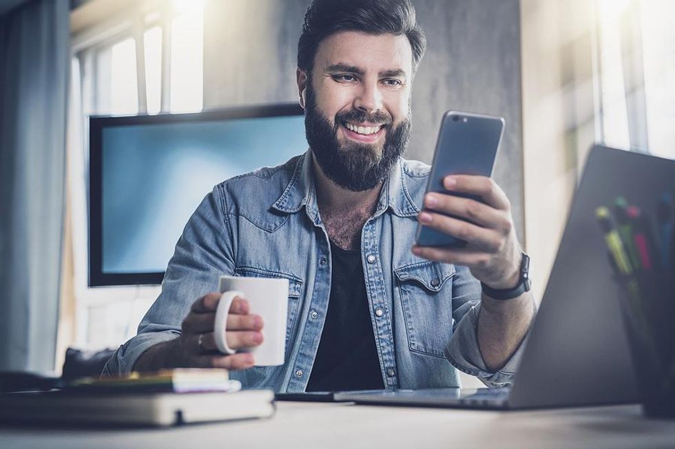 Job seekers research a company's social media account on his phone.