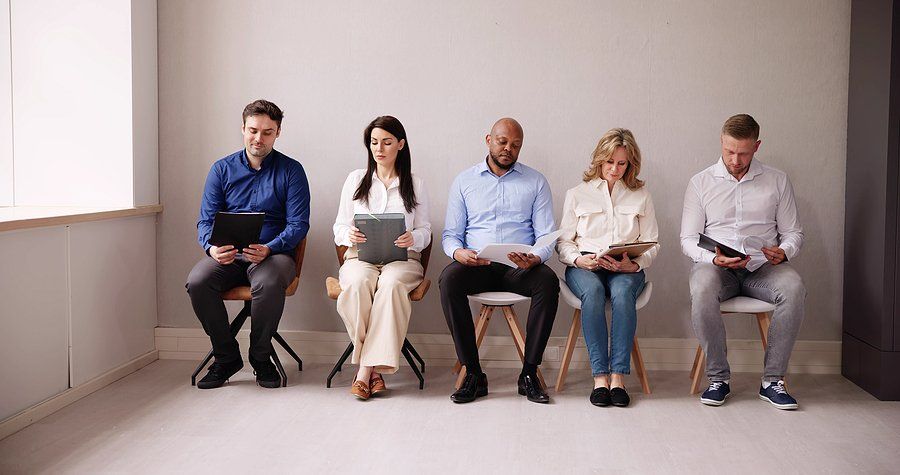 Job seekers wait and prepare for a job interview