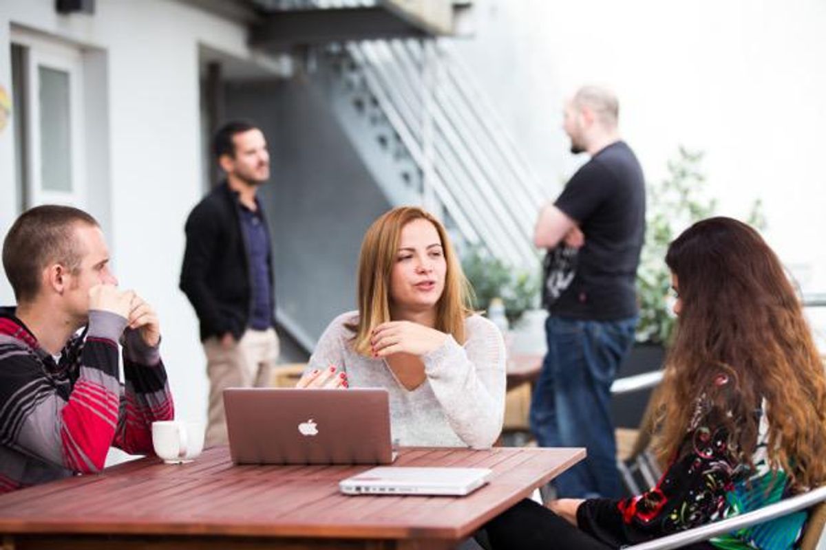 Kinsta employees collaborate with each other