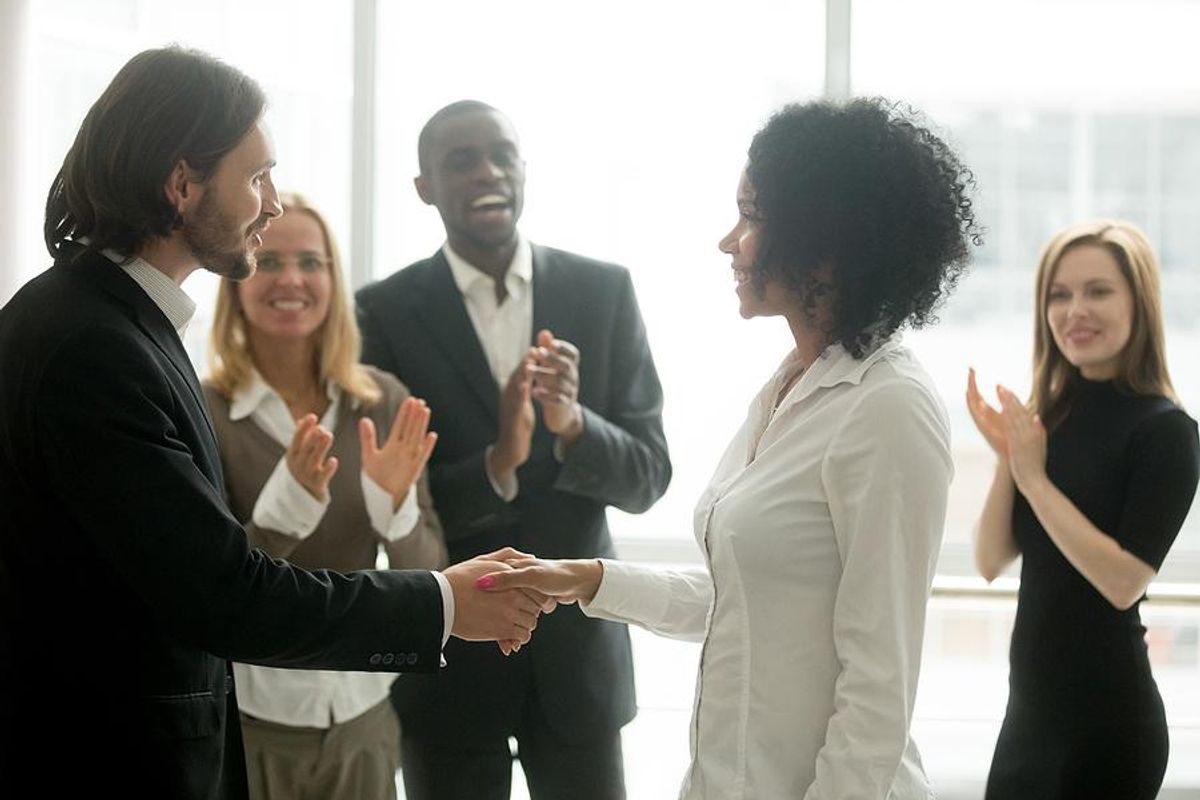 Leader congratulates and motivates his employees