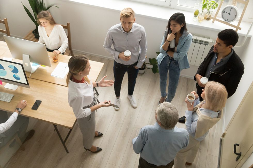 Leader developing her communication skills at work during a team meeting