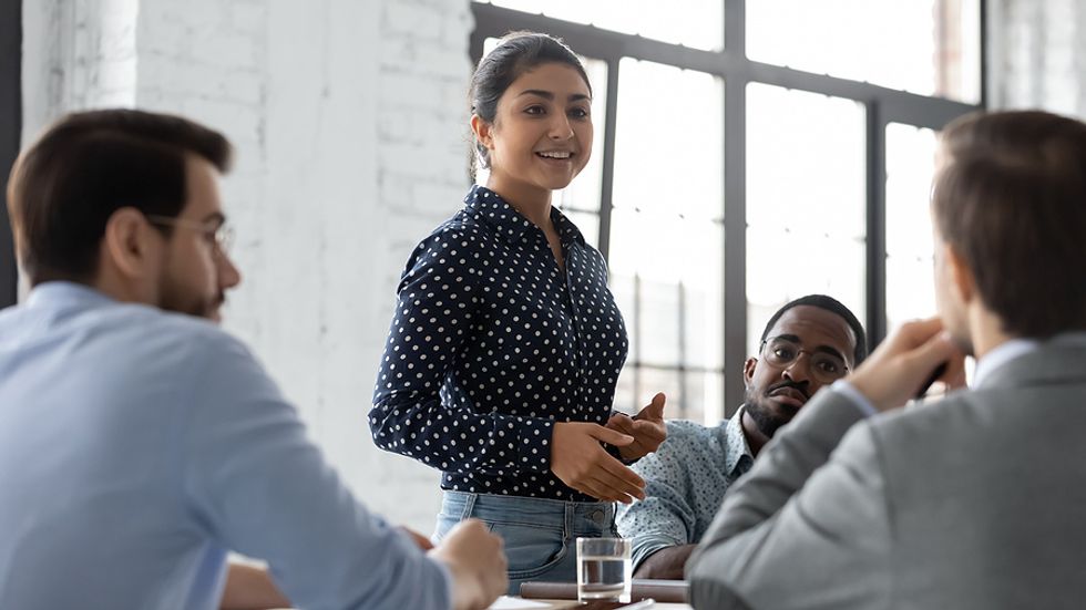 Leader effectively communicates during a work meeting