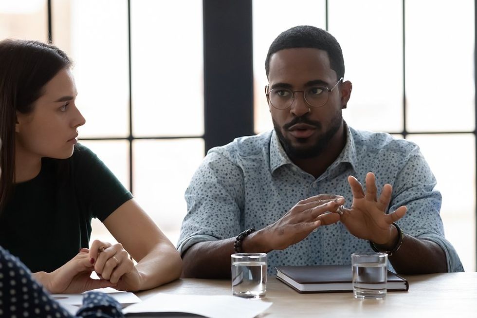 Leader shares difficult news with employees during a work meeting