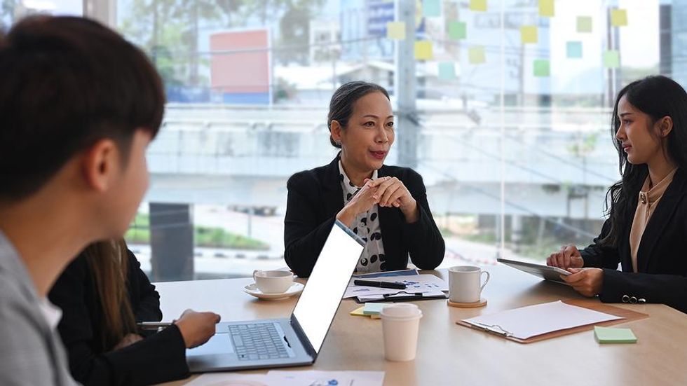 Leader talks to her colleagues during a work meeting