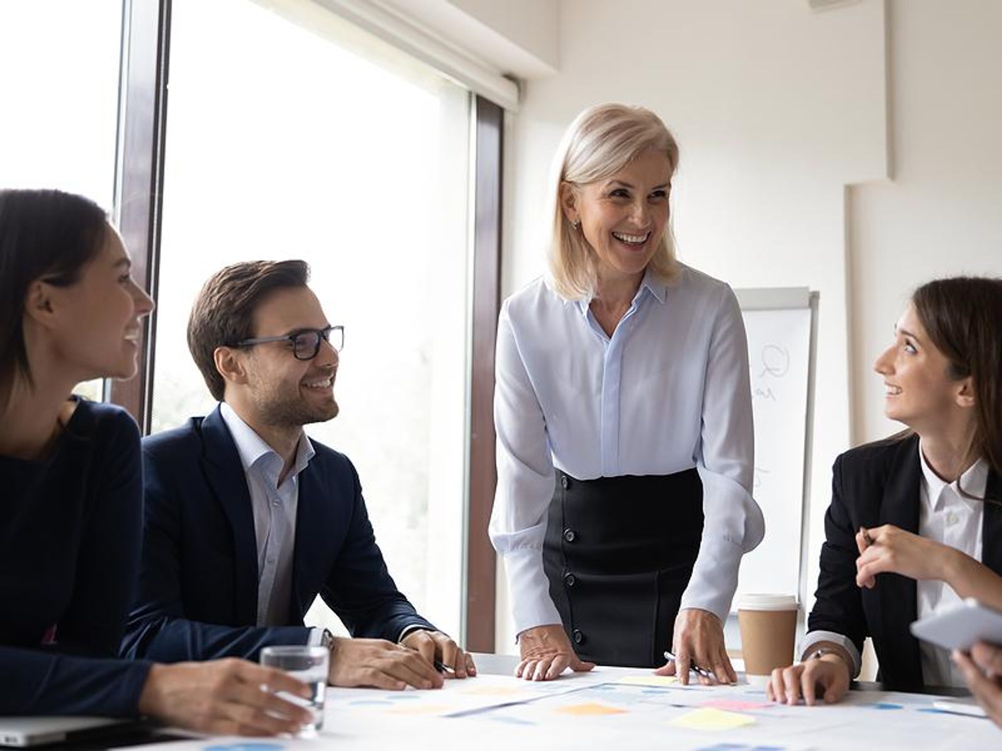 Leader talks to her employees during a team meeting