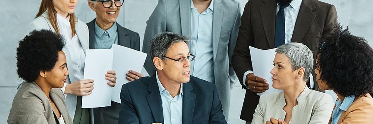 Leader talks to his colleagues during a team meeting