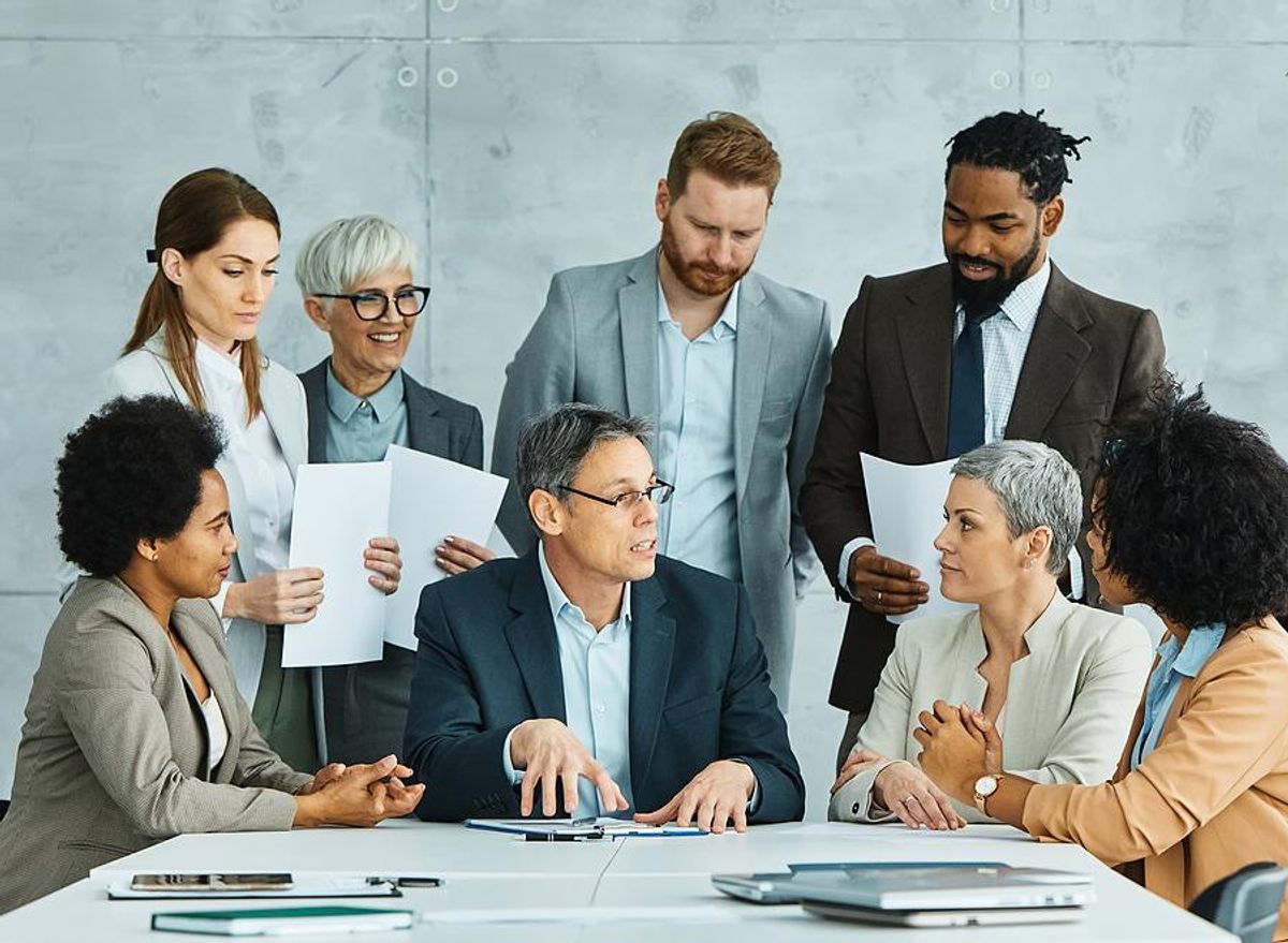 Leader talks to his colleagues during a team meeting
