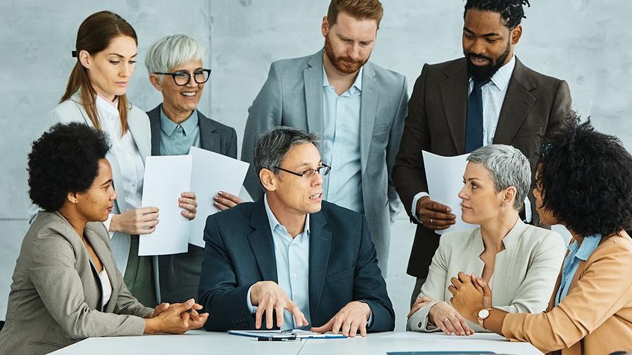 Leader talks to his colleagues during a team meeting